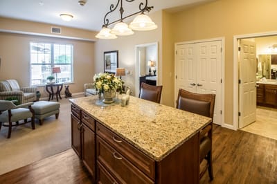 Bright and inviting common area with seating and a kitchen island