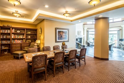 Bright common area with dining table and bookshelves