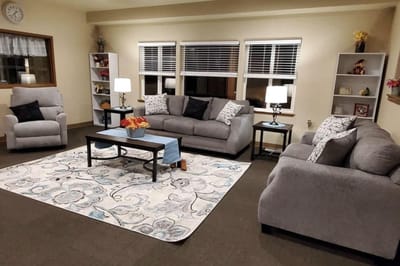 Cozy common area with grey sofas and lamps
