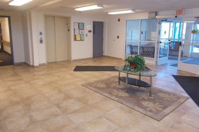 Interior view of a common area with seating and plants