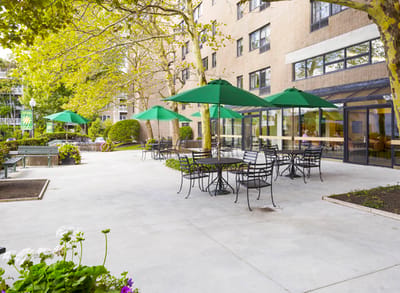 Outdoor patio with green umbrellas and seating