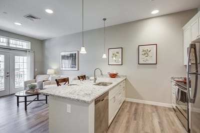 Modern kitchen area with seating and natural light