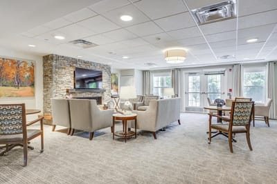 Bright common area with seating and a fireplace