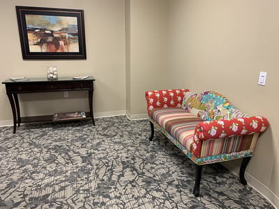 A colorful interior seating area with a patterned couch
