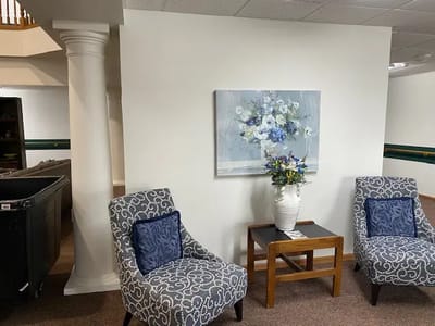 Cozy sitting area with floral artwork and chairs
