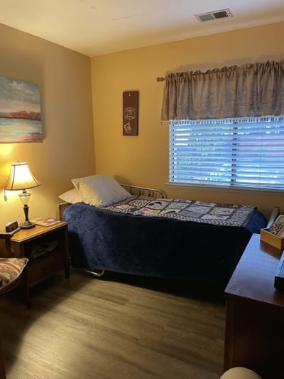 Cozy resident room with a bed and lamp
