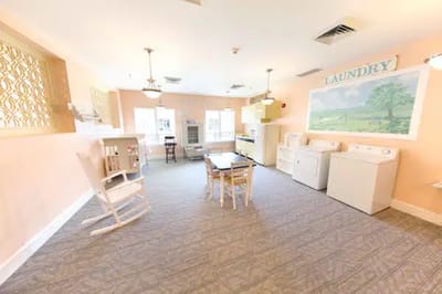 Bright laundry room with washing machines and seating
