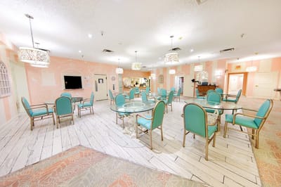 Bright dining area with teal chairs and tables