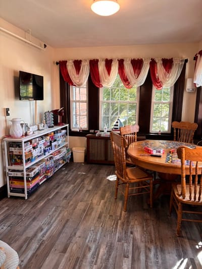 Interior activity room with seating and a puzzle station
