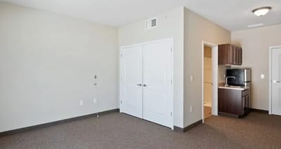 Interior view of a private resident room with kitchenette