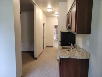 Interior view of a hallway with kitchenette