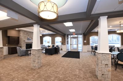 Bright common area with seating and large windows