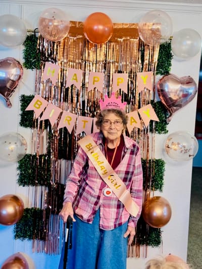 Resident celebrating a birthday in a decorated common area