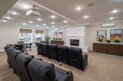 Comfortable common area with plush seating and a projector