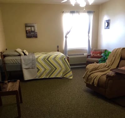 Cozy private resident room with bed and seating area