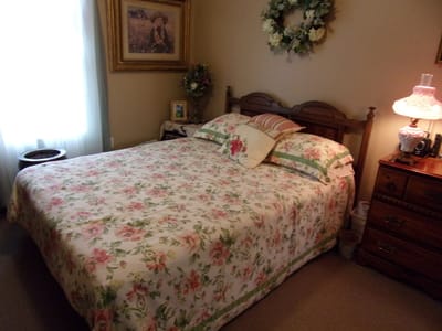 Cozy bedroom with floral bedding and natural light
