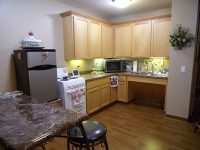 Cozy kitchen area in a resident unit with wooden cabinets