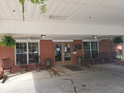 Front entrance of Dermott City Nursing Home with rocking chairs