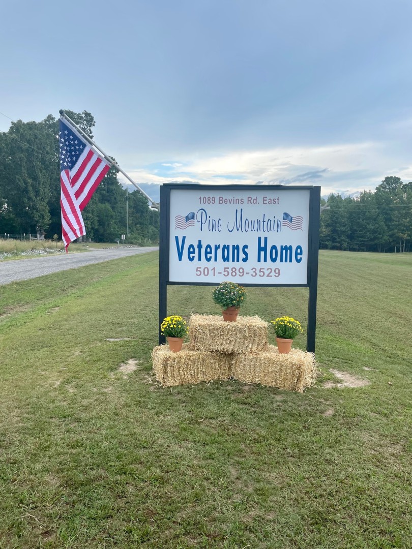 Sign for Pine Mountain Veterans Home with American flag
