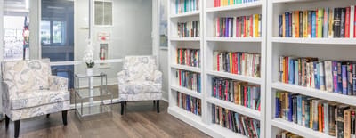 Cozy reading area with bookshelves and chairs