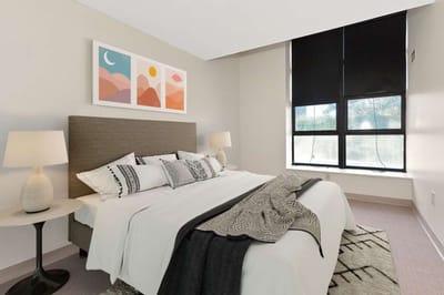 A well-decorated private resident room with a cozy bed