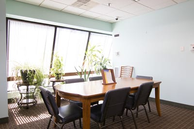 Bright interior room with a large table and plants
