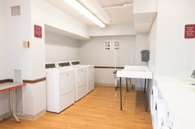 Laundry room with machines and clean surfaces