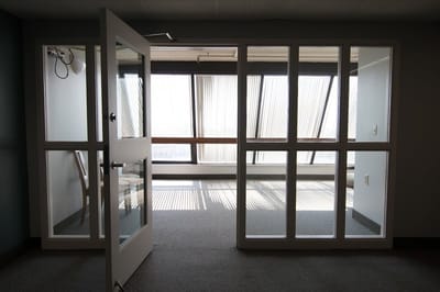 Interior view of a room with large windows and light patterns