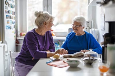 Two women engaging in conversation in a kitchen