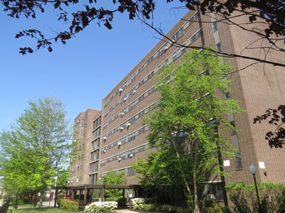 Exterior of the Lawrence Housing Authority building surrounded by trees
