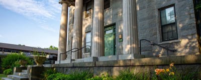 Exterior view of the Grinnell Mansion entrance with columns