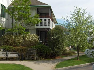 Exterior view of a senior living facility with gardens