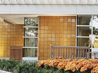 Exterior view of the facility with flowers and seating area