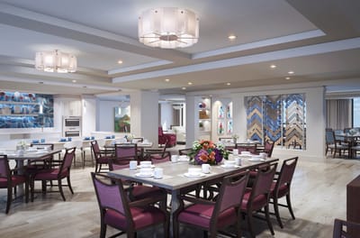 Bright dining room with tables set for meals