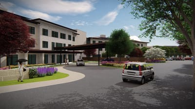 Entrance of an assisted living facility with landscaped surroundings