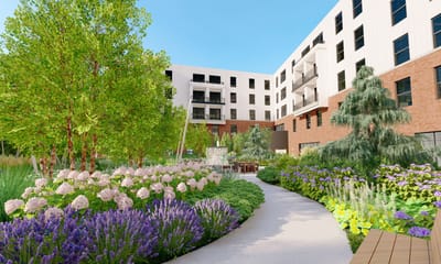 Lush garden courtyard with walking path and flowers