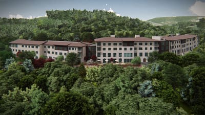 Aerial view of a senior living facility surrounded by greenery