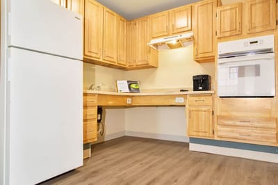 A kitchen area in a senior living apartment
