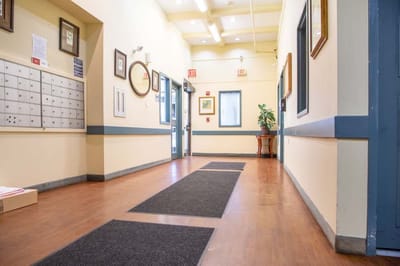Bright hallway with mailboxes and artwork