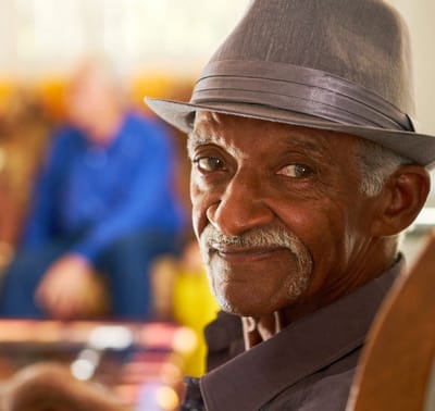 Close-up of a smiling senior man in a common area