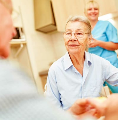 Resident interacting with a staff member in care facility