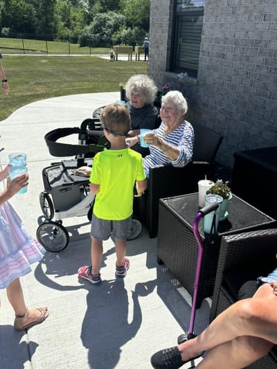 Residents interacting with children in an outdoor space