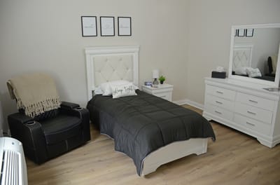 Cozy private resident room with bed and furniture