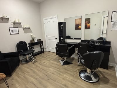 Interior view of a beauty salon with chairs and mirrors