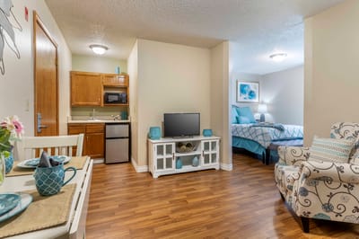 Interior view of a cozy resident suite with kitchenette
