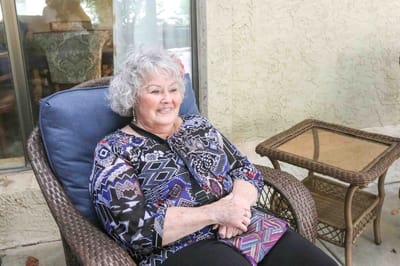 Resident enjoying a moment on a cozy chair