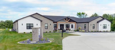 Exterior view of the assisted living facility with landscaped grounds