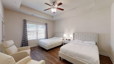 Shared resident room with two beds and seating area