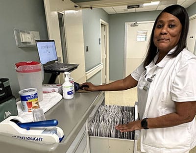 Staff member at the nursing facility assisting with tasks