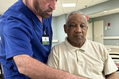 Staff assisting a resident in a common area
